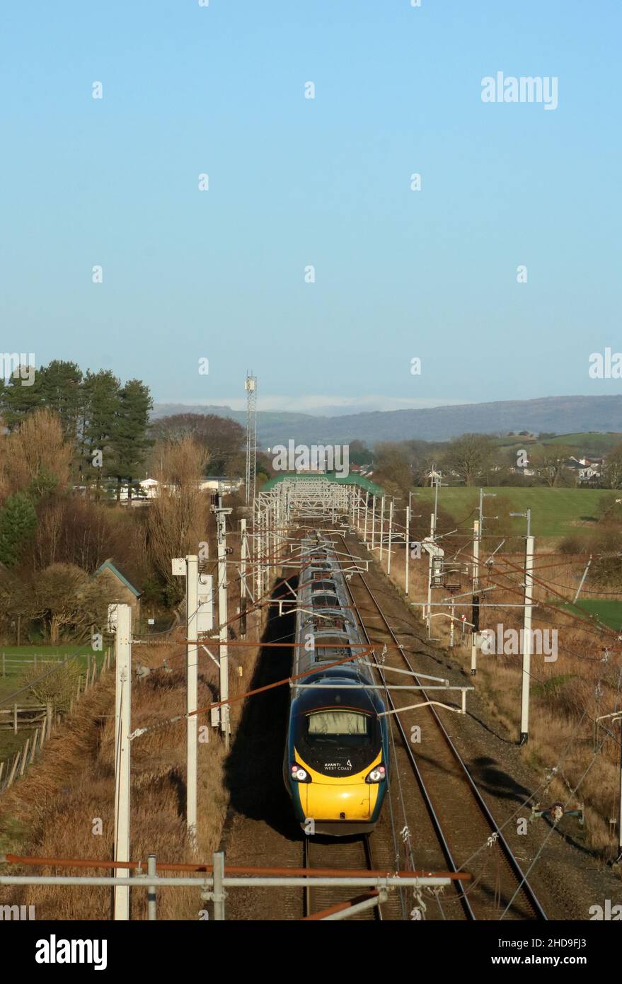 Avanti West Coast pendolino electric train on West Coast Main Line passing Hest Bank, Lancashire on 4th January 2022 with an Anglo Scottish service. Stock Photo
