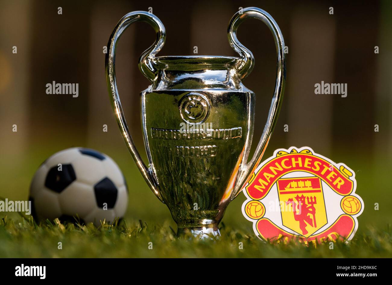 August 27, 2021 Manchester, UK. Manchester United F.C. football club emblem and the UEFA Champions League Cup on a green turf Stock Photo - Alamy