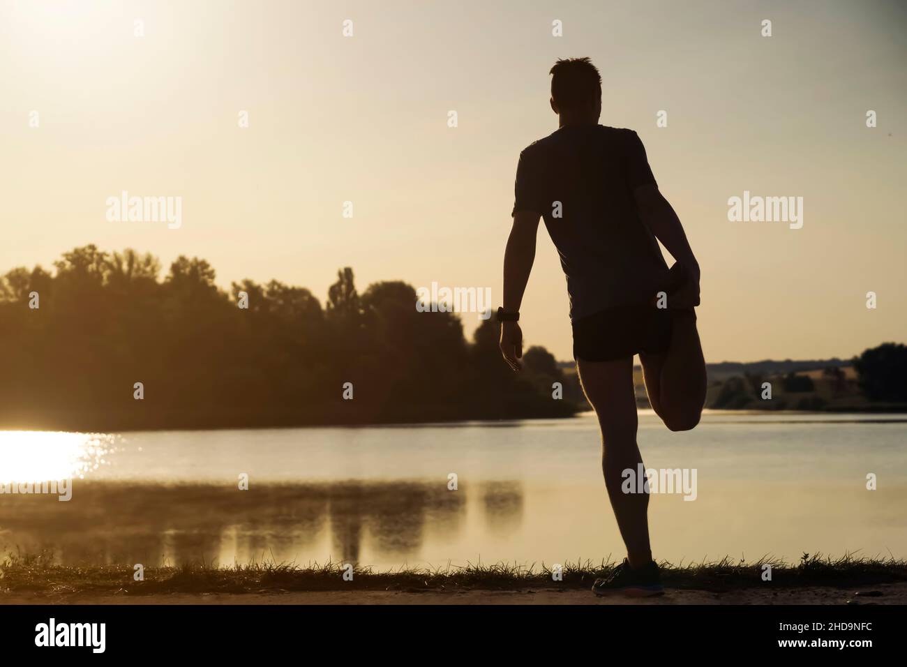 Man is training, running, warming up outdoor. Stock Photo