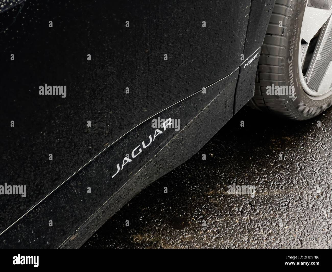 Jaguar logotype on a new electric SUV car covered with raindrops Stock Photo