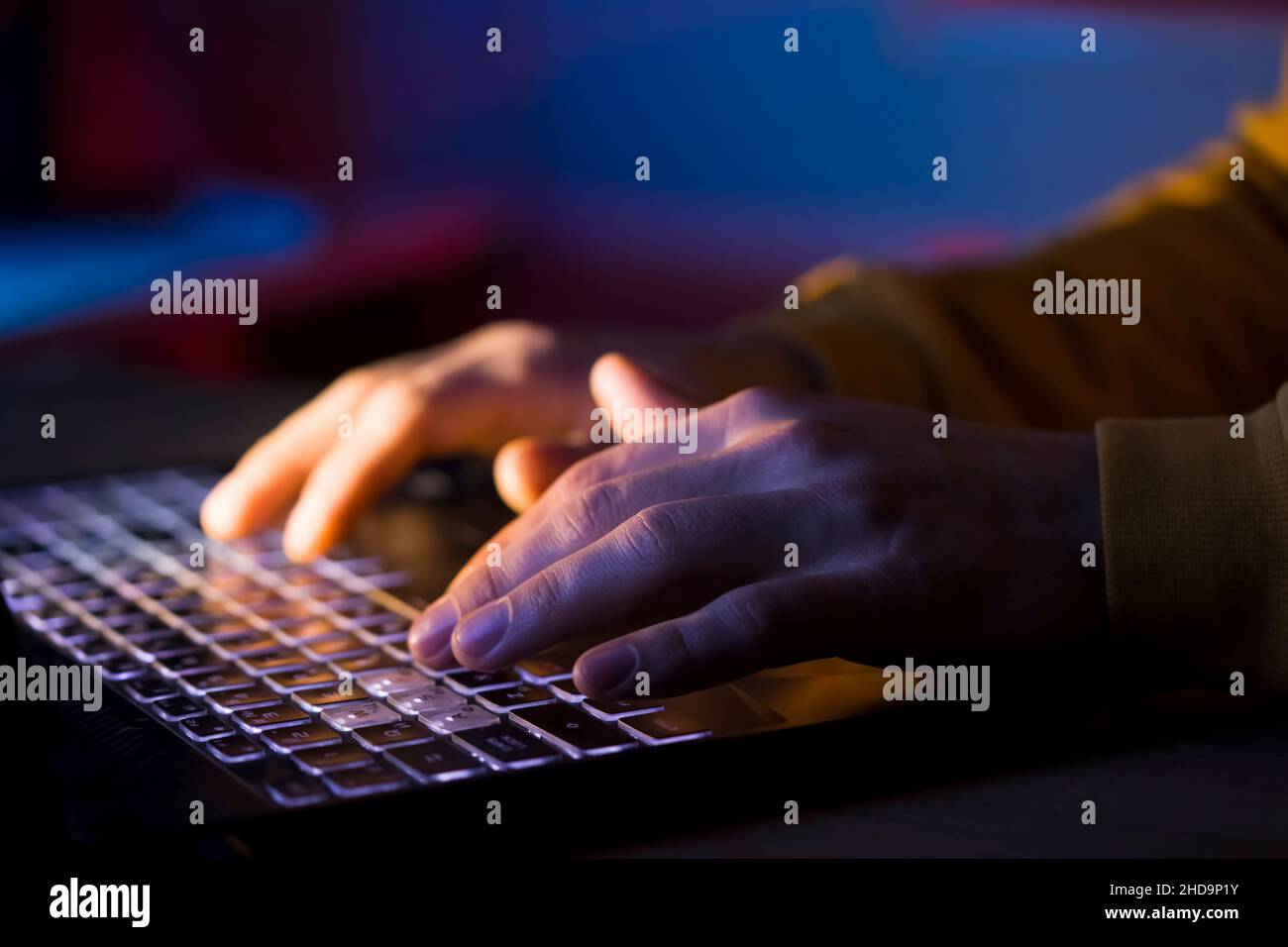 Hands types on a laptop keyboard. Stock Photo