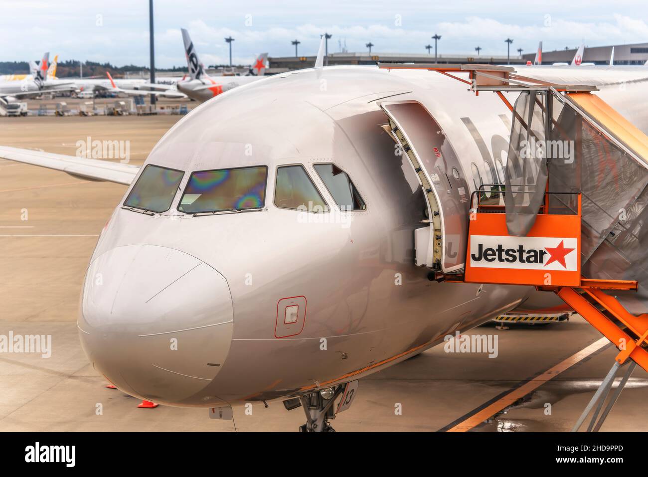 tokyo, japan - december 06 2021: Close up on the head of an Airbus plane from Japanese low-cost carrier airline jetstar airways boarding passengers on Stock Photo