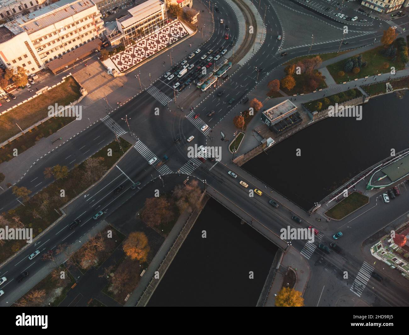 Look down on autumn city, Pavlivska Square and Lopan river. Downtown streets traffic aerial rooftop at sunset in Kharkiv, Ukraine Stock Photo