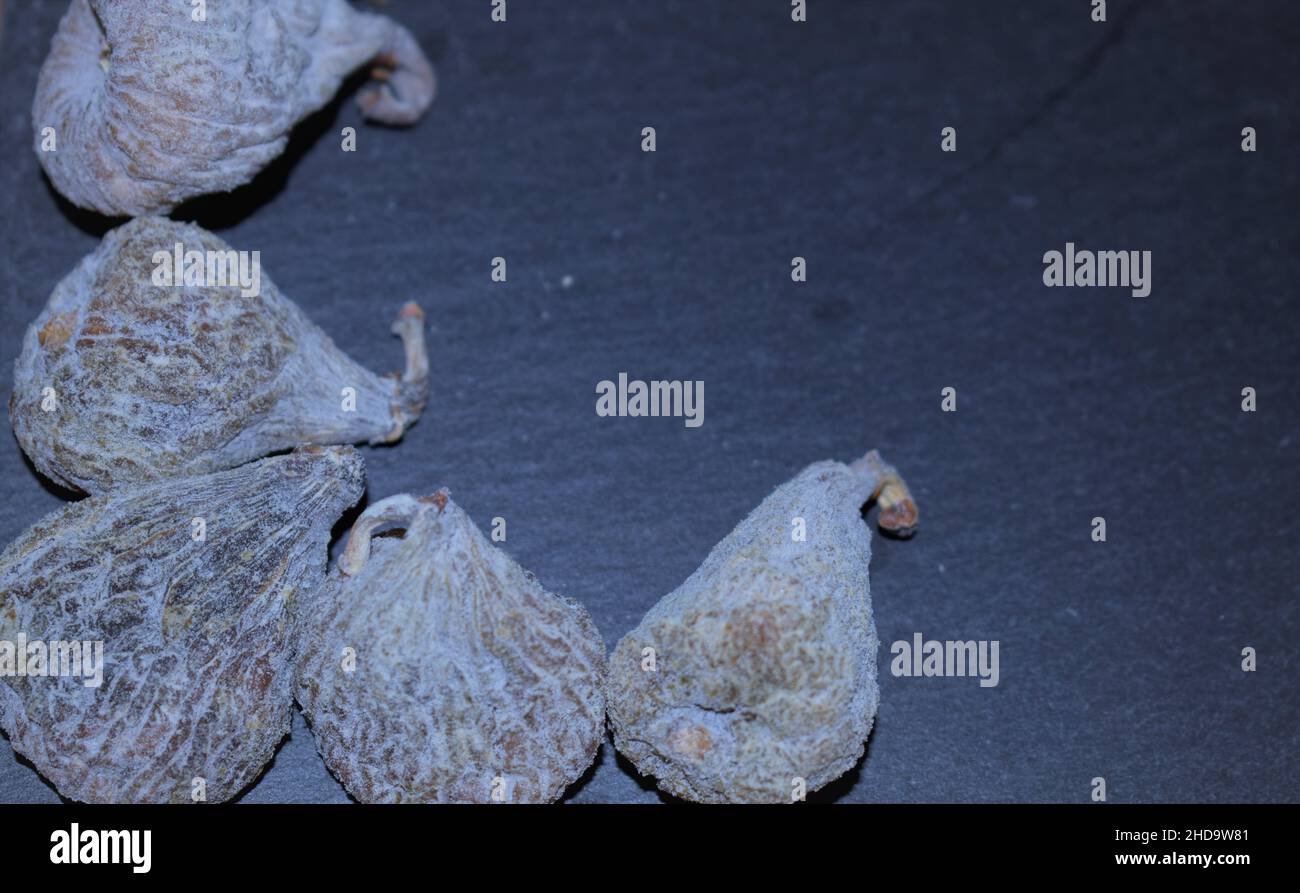 Various dried figs on black slate tray Stock Photo