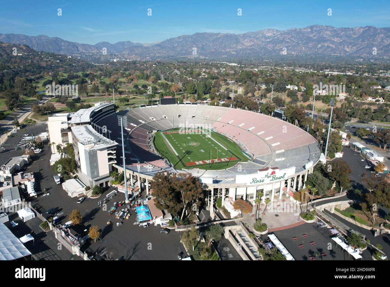 An aerial view of the Rose Bowl Stadium football field with the logos