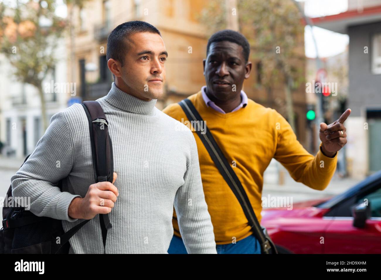 Two men going through town streets Stock Photo