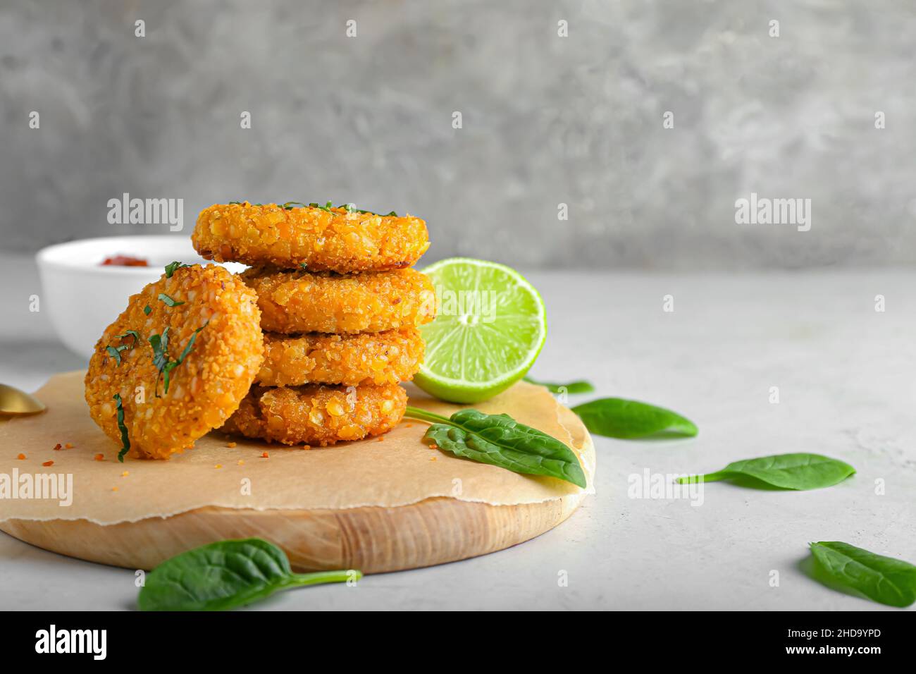 Board with tasty lentil cutlets on grey background Stock Photo - Alamy