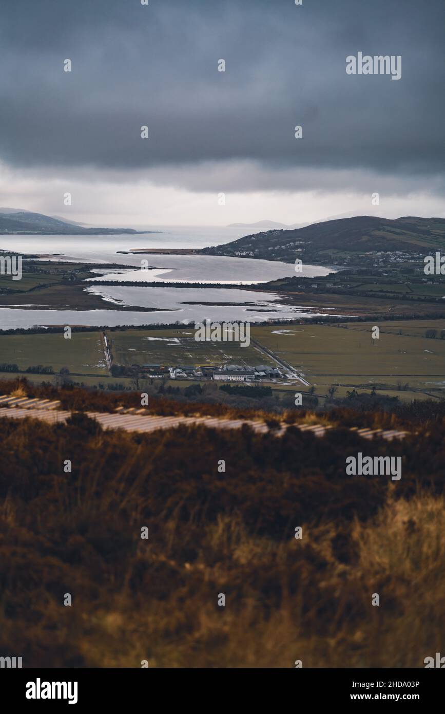 Scenic view of the farmland and mountain in Ireland under a gloomy sky Stock Photo