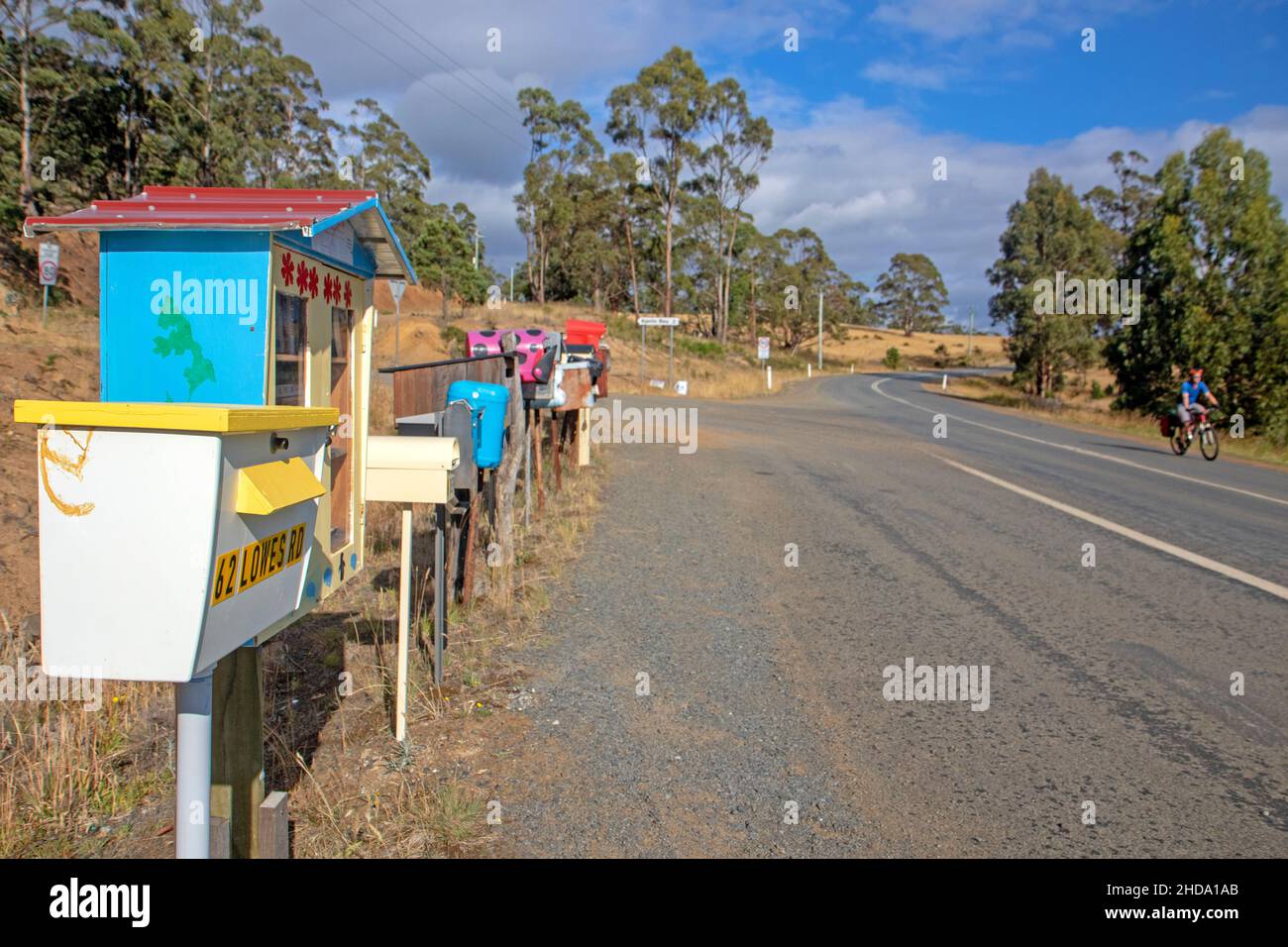 Cycling past a bank of letterboxes on Bruny Island Stock Photo