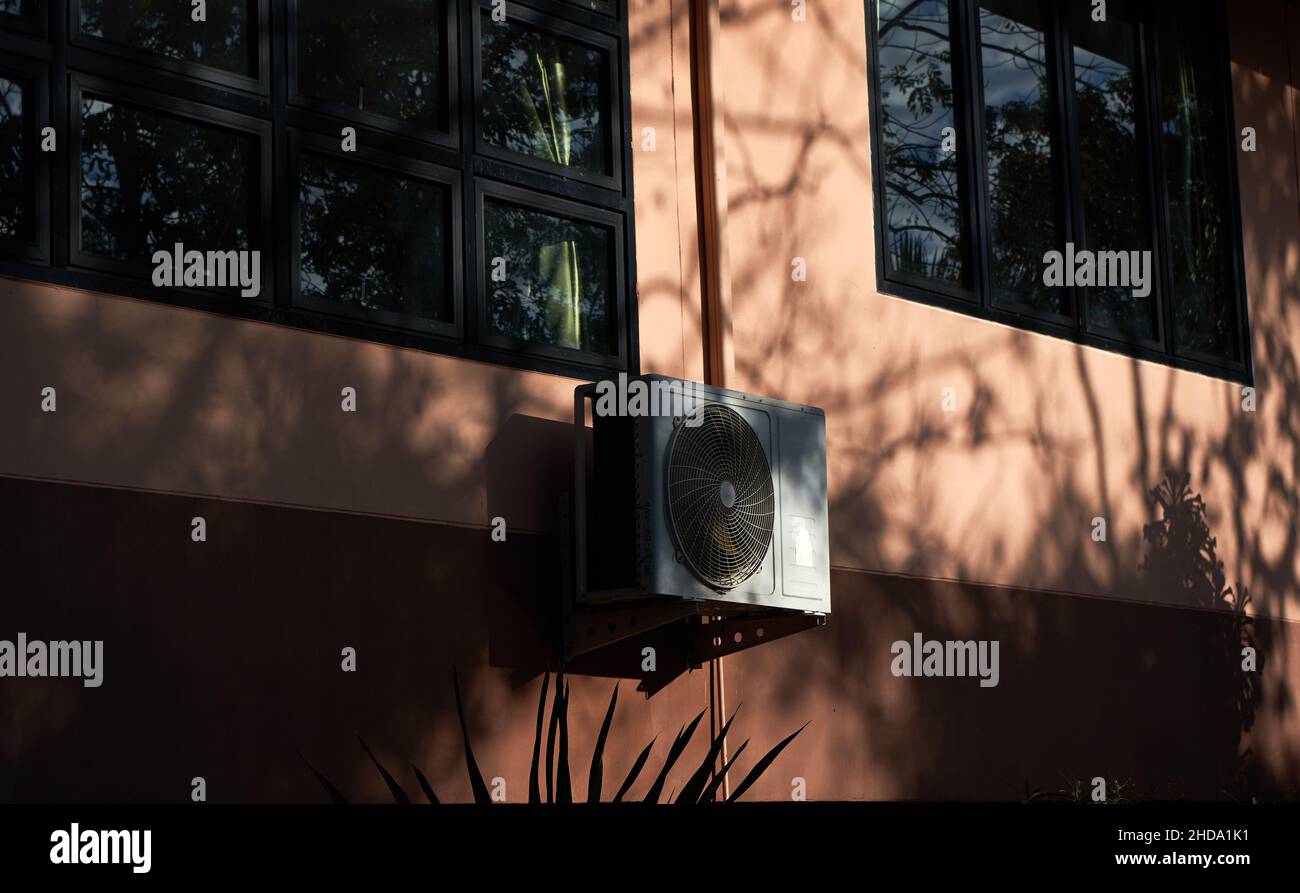 An air conditioner compressors at wall of building Stock Photo - Alamy