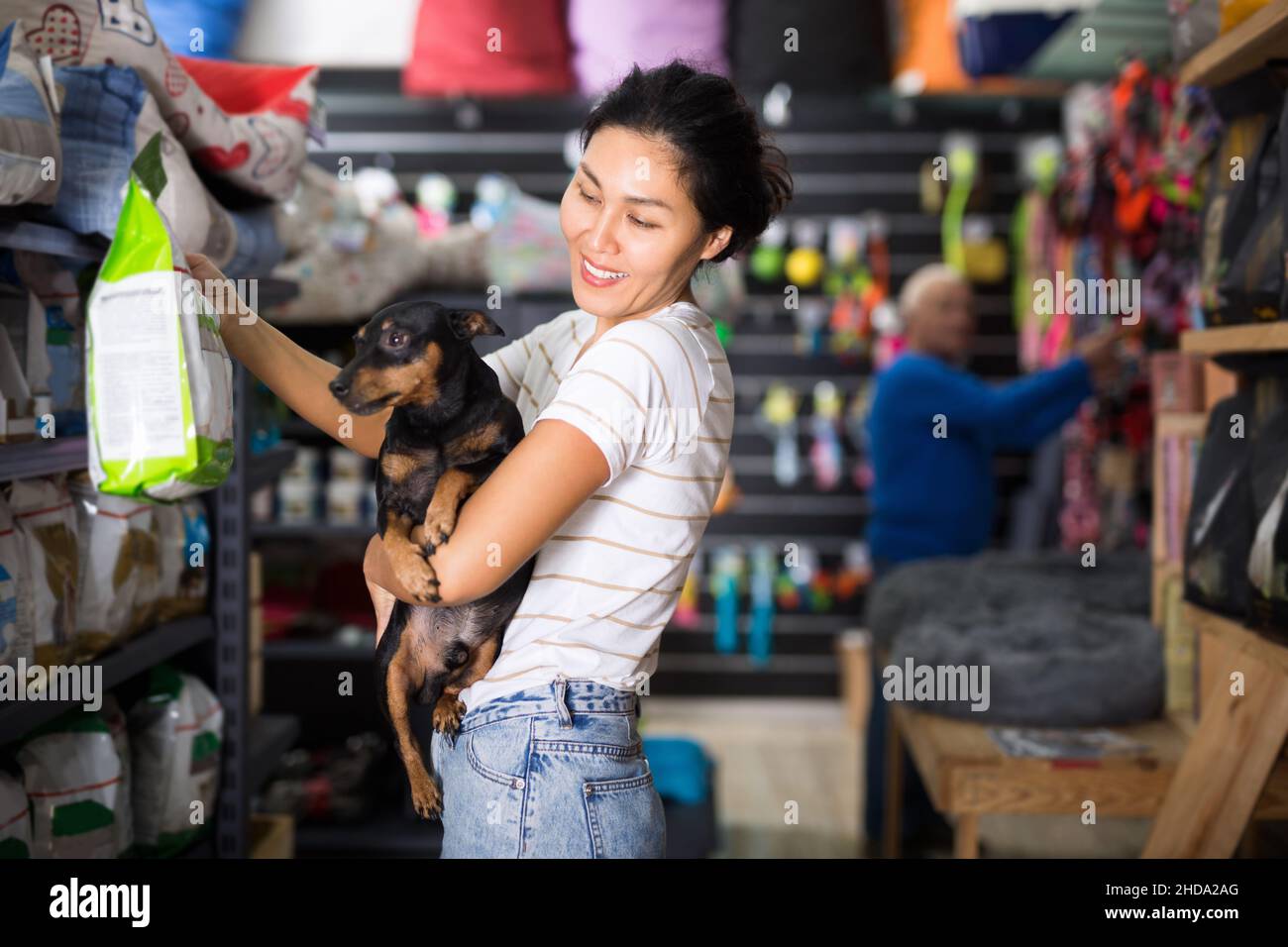 Woman choosing dog food in pet shop Stock Photo Alamy