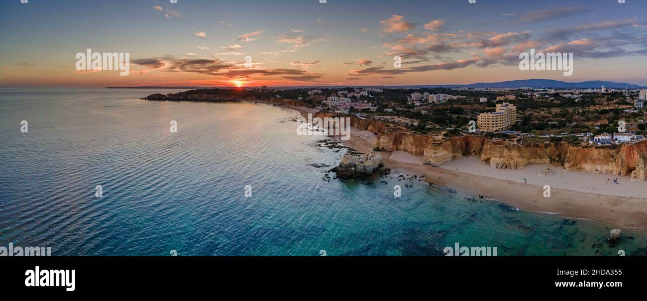 Aerial sunset over Portimao Praia do Vau beach, famous tourist destination in Western Algarve, Portugal. Stock Photo