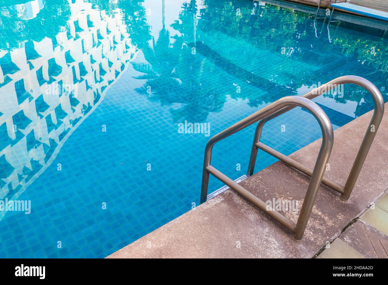 Grab bars ladder in the blue swimming pool background Stock Photo - Alamy