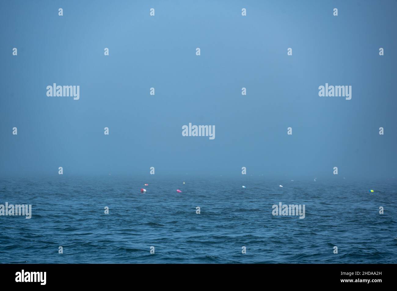 Lobster trap buoy floating on a choppy ocean in the Atlantic Ocean Stock Photo