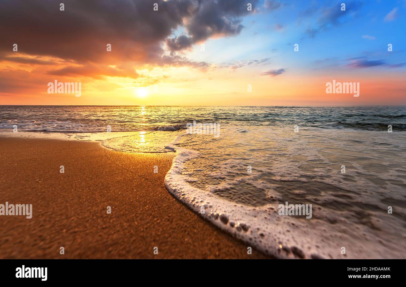 Fiery and dramatic sunset across the lake in summer . Stock Photo