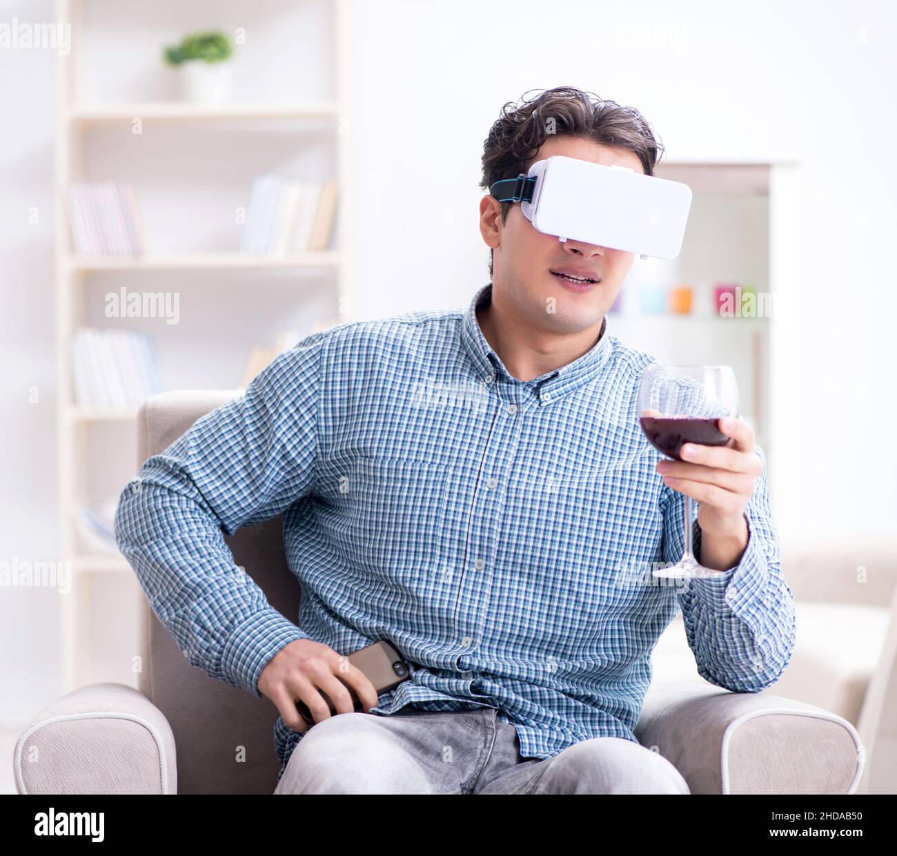 The young man drinking wine at home Stock Photo - Alamy