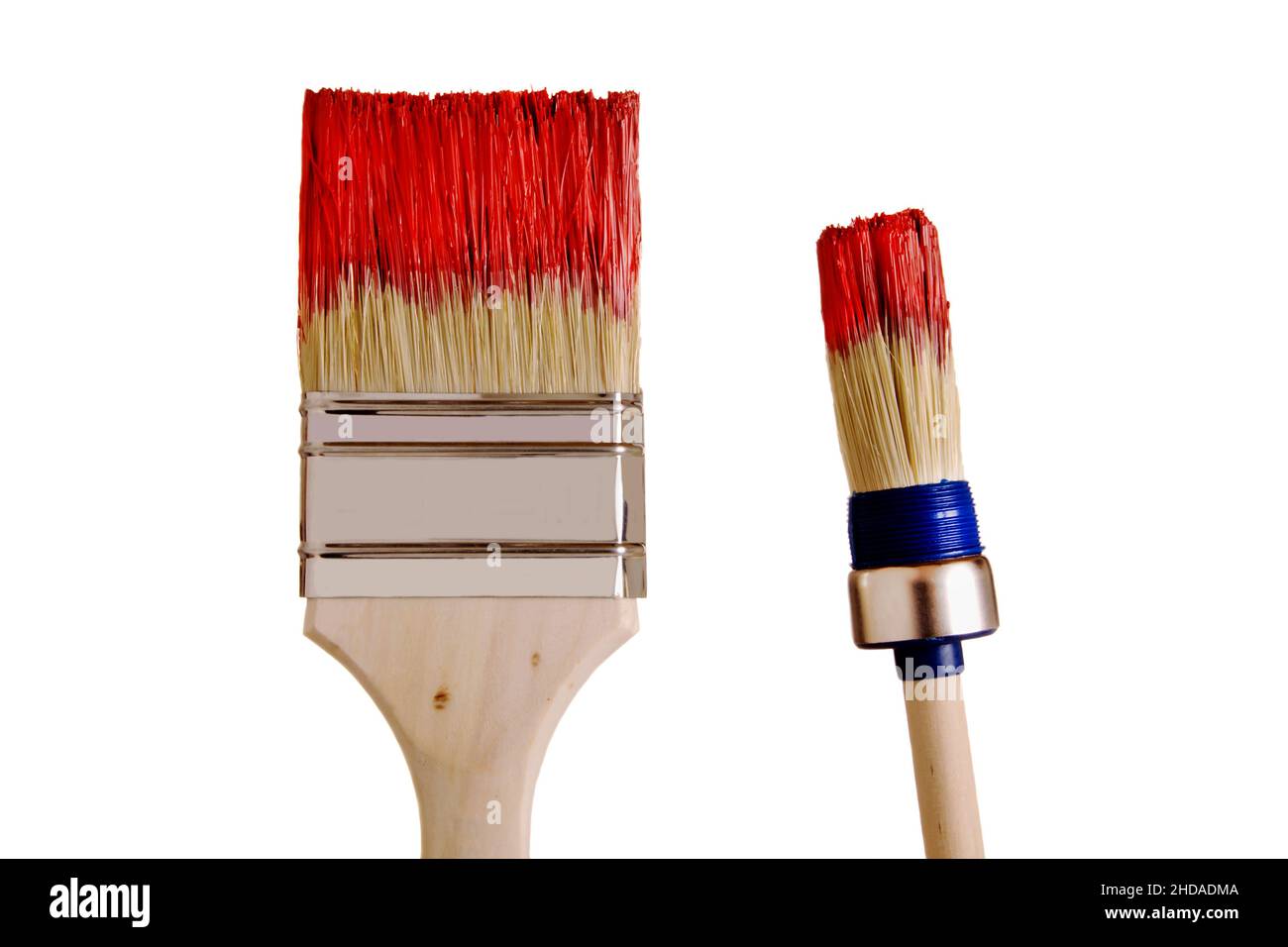 two paint brush dipped in red paint, isolated Stock Photo