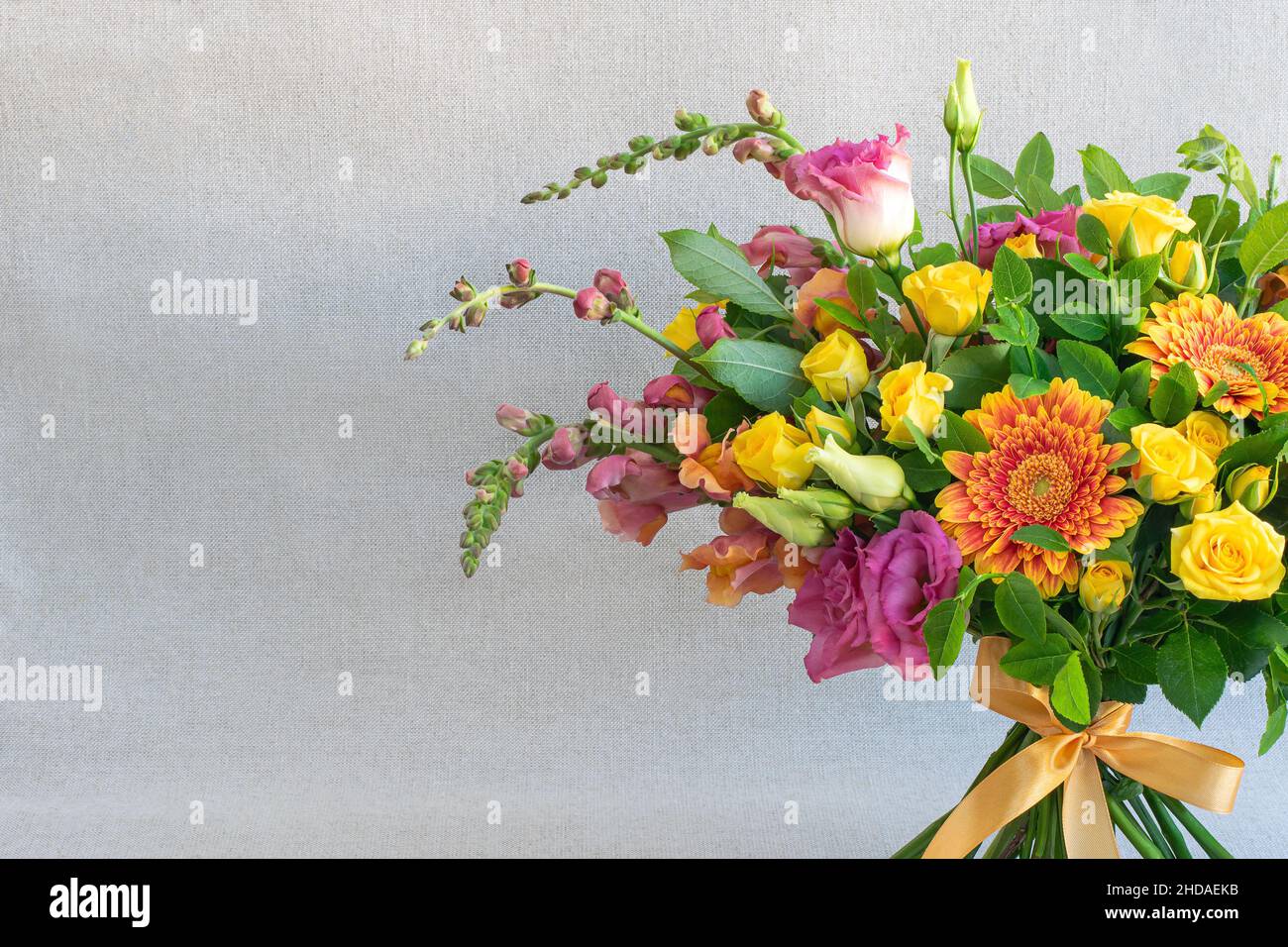 Bright bouquet of decorative and wild flowers on light background Stock Photo