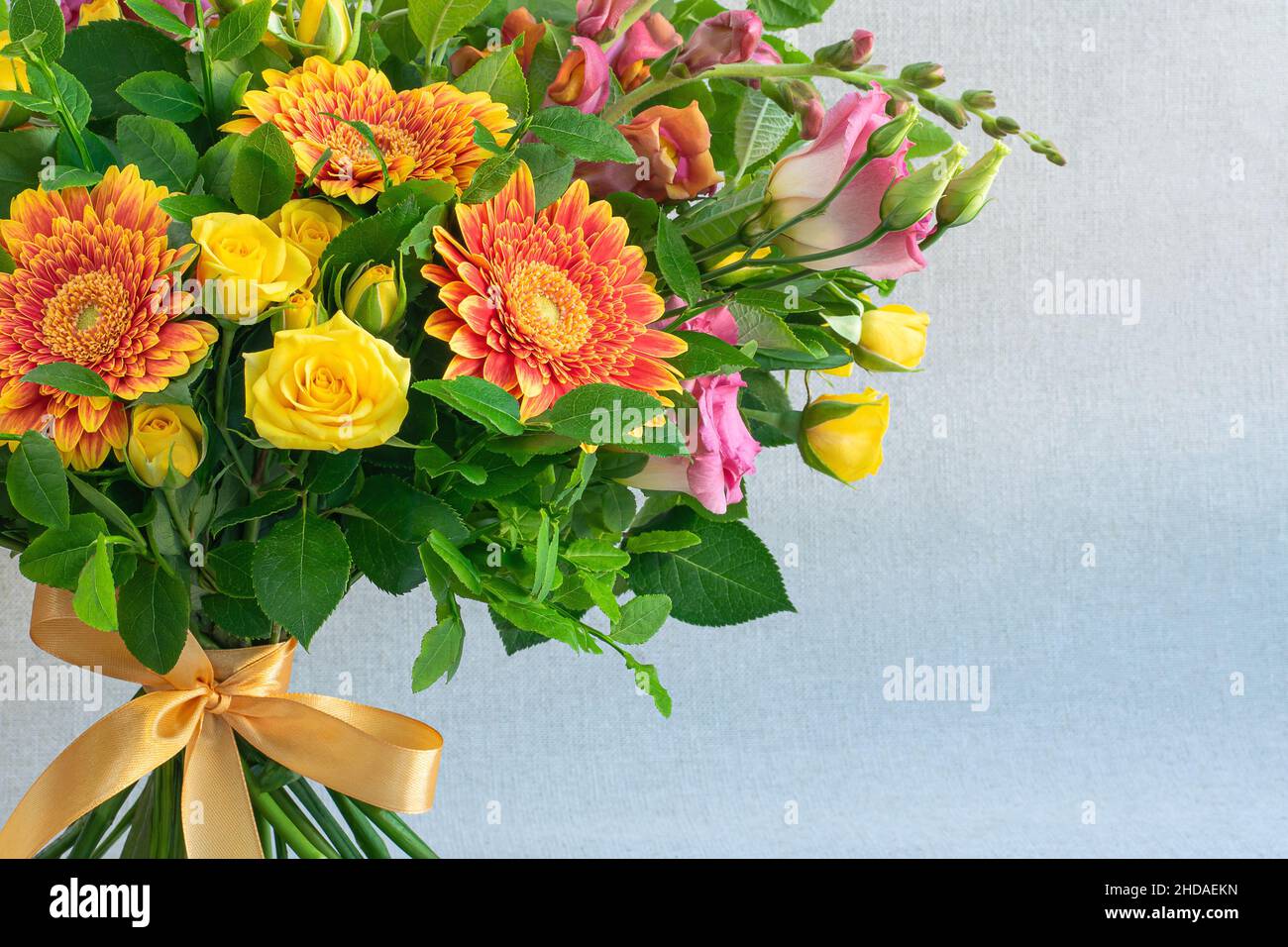 Floral arrangement with gerberas and roses on light background Stock Photo