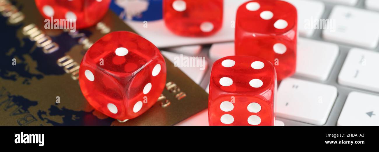 Dice plastic credit bank cards and computer keyboard on table