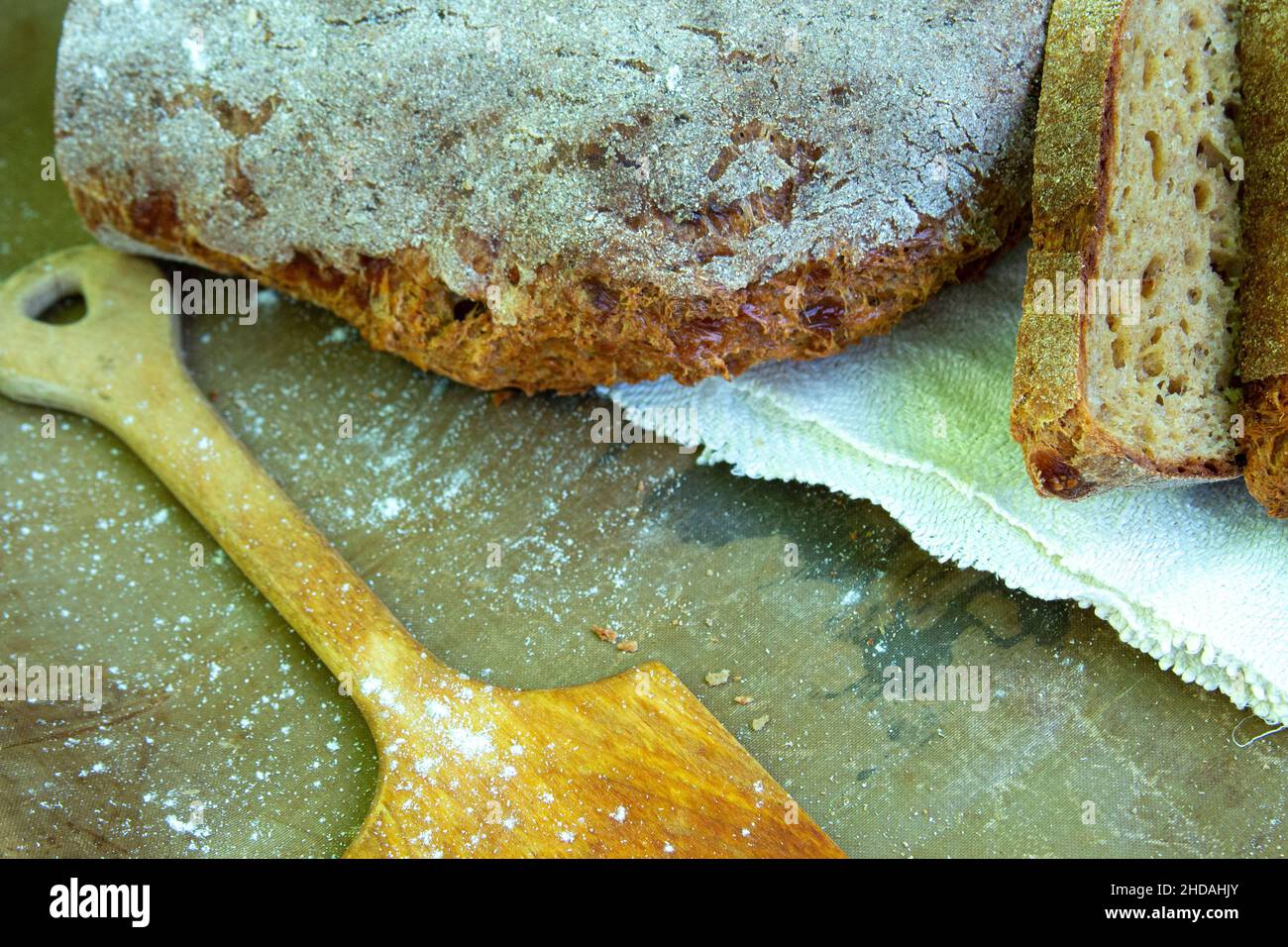 Fresh whole grain bread sprinkled with flour lies on a towel Stock ...