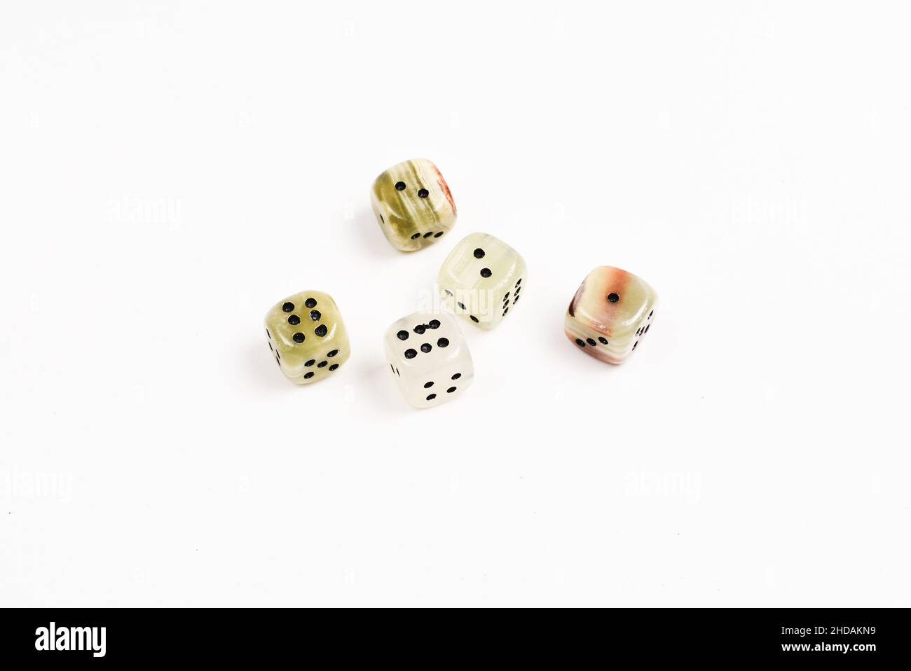 Dices made of natural stone on a white background. Copy space. Gaming. Stock Photo