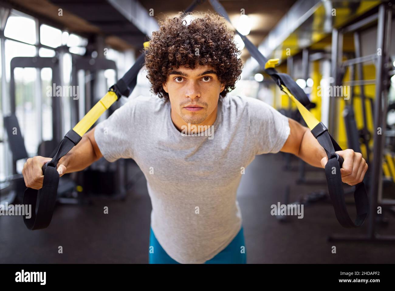Muscular bodybuilder handsome man doing exercises in gym Sport people