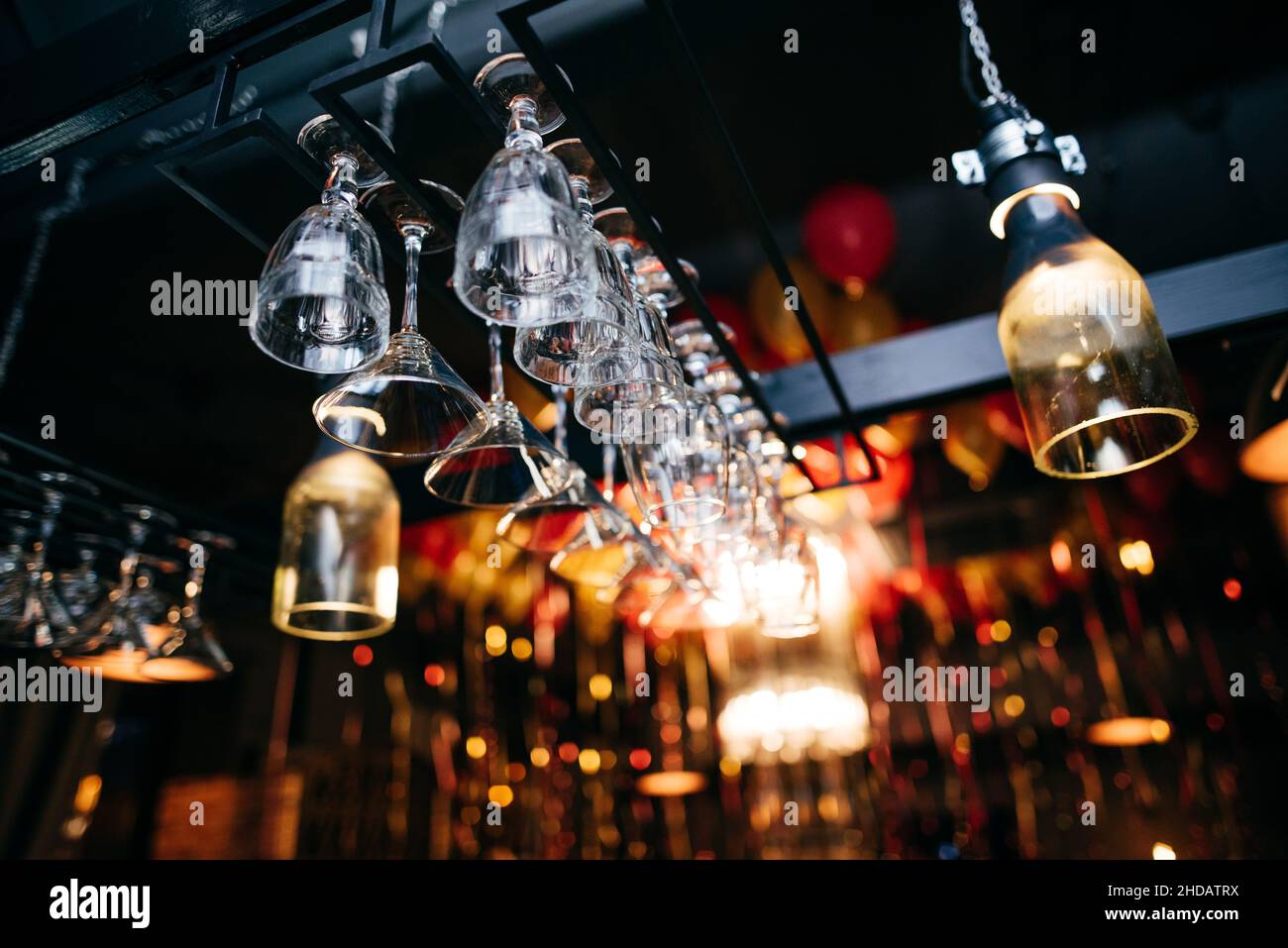 Rows of empty wine glasses on the bar counter in the restaurant or bar. Stock Photo