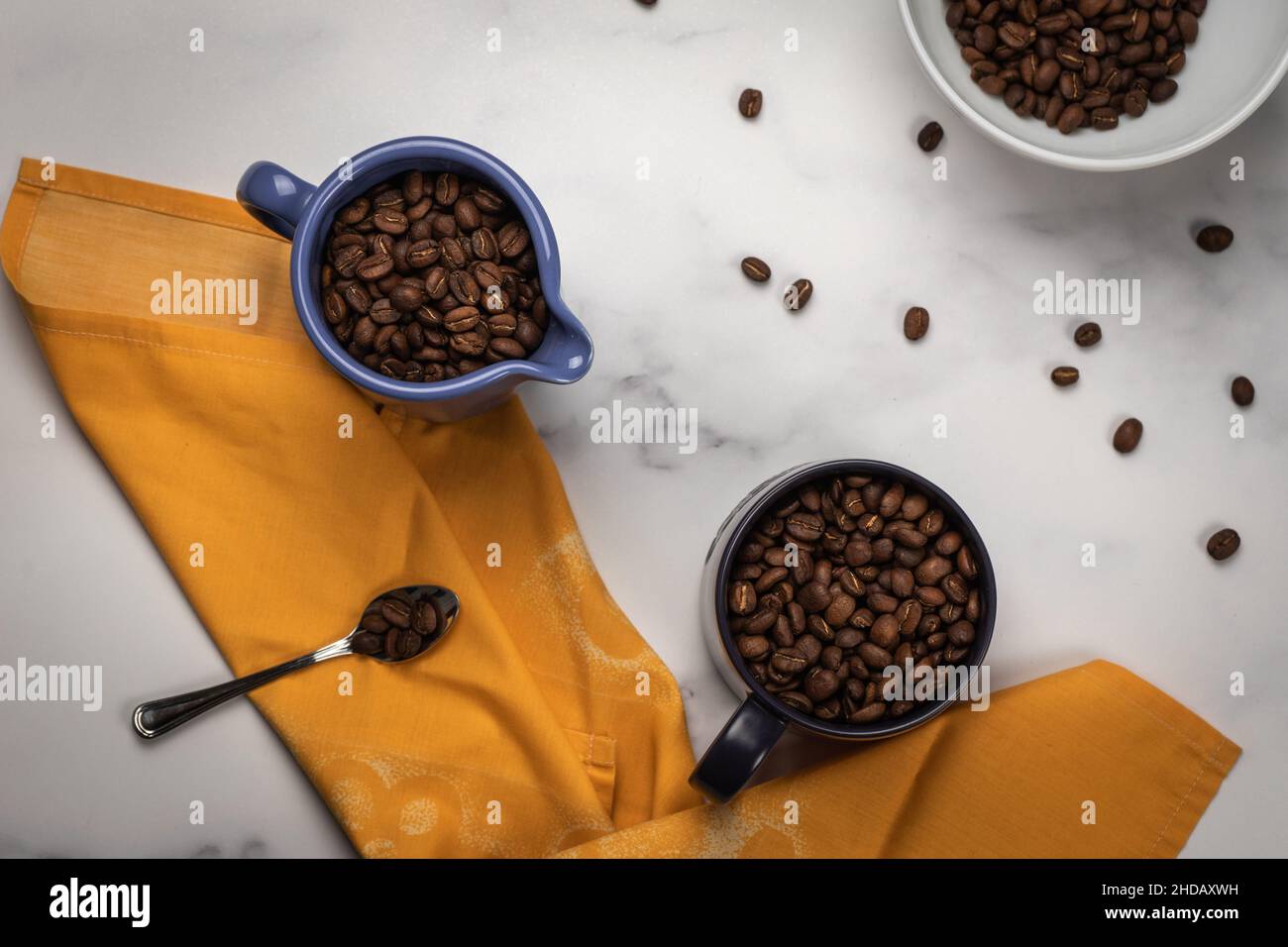 Top view of a messy kitchen table with bowls of coffee beans Stock Photo
