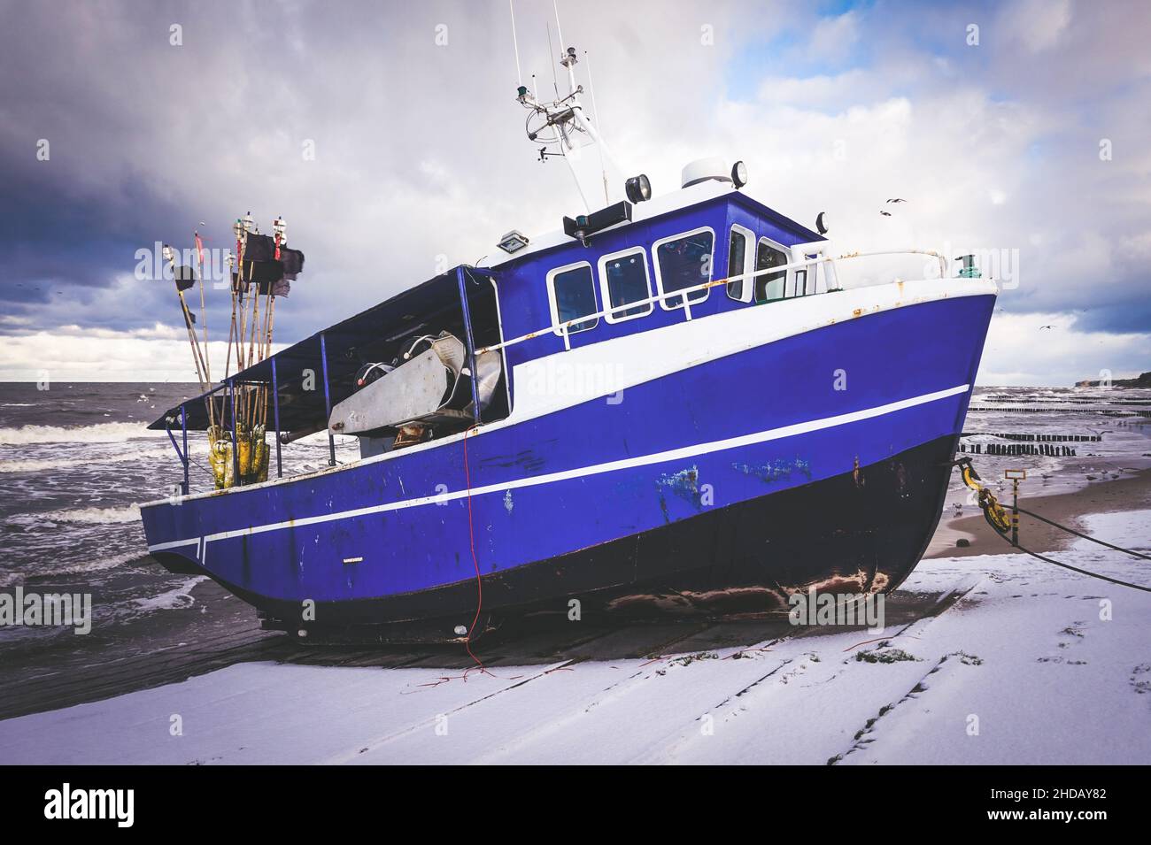Blue fishing boat on a coast Stock Photo - Alamy