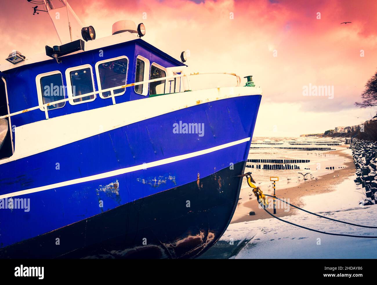 Blue fishing boat on a coast Stock Photo - Alamy