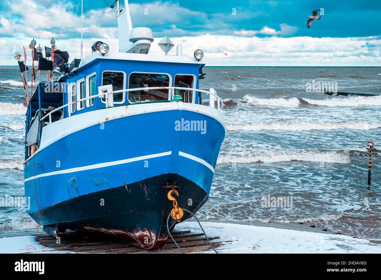 Blue fishing boat on a coast Stock Photo - Alamy