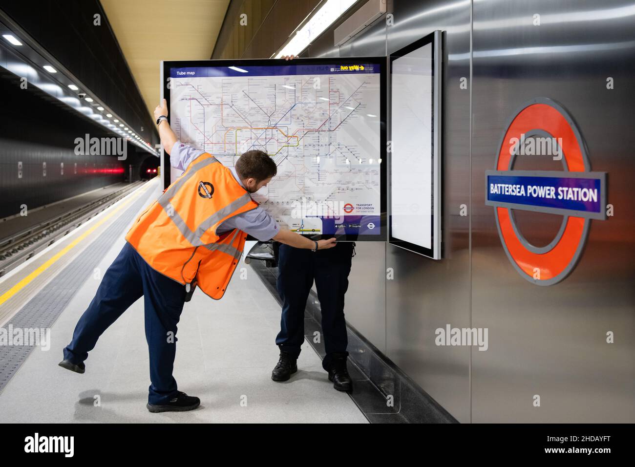 London Underground staff installing new rail and tube maps at Battersea Power Station, ahead of its opening on Monday 20th September 2021 Stock Photo
