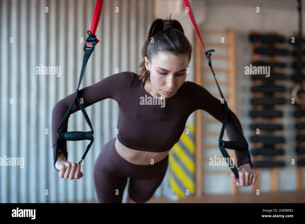 Fit woman doing push-up exercise with trx Stock Photo - Alamy