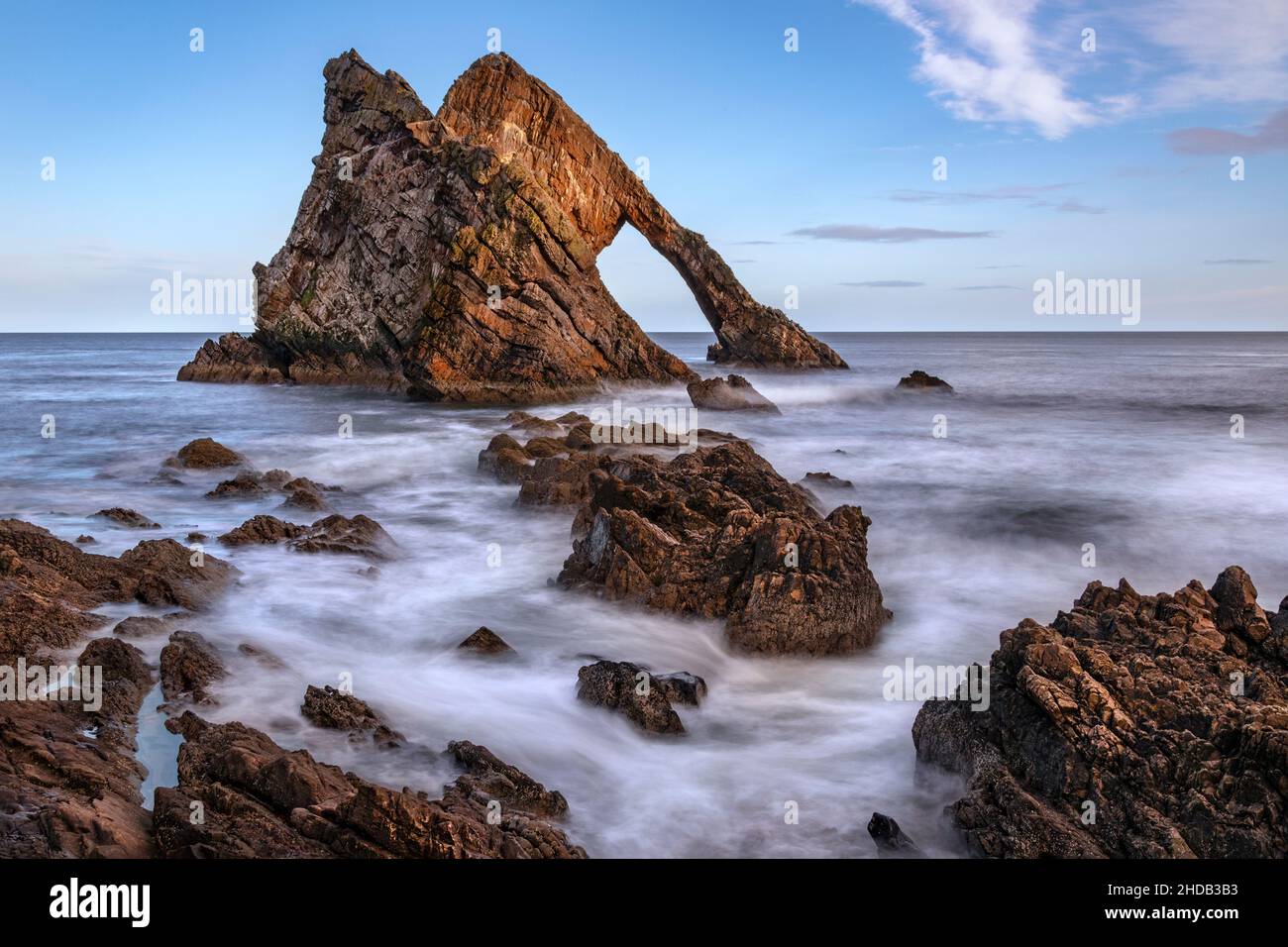 Bow Fiddle Rock - a natural sea arch near Portknockie on the northeast coast of Scotland. It is composed of Quartzite, a metamorphic rock which was or Stock Photo