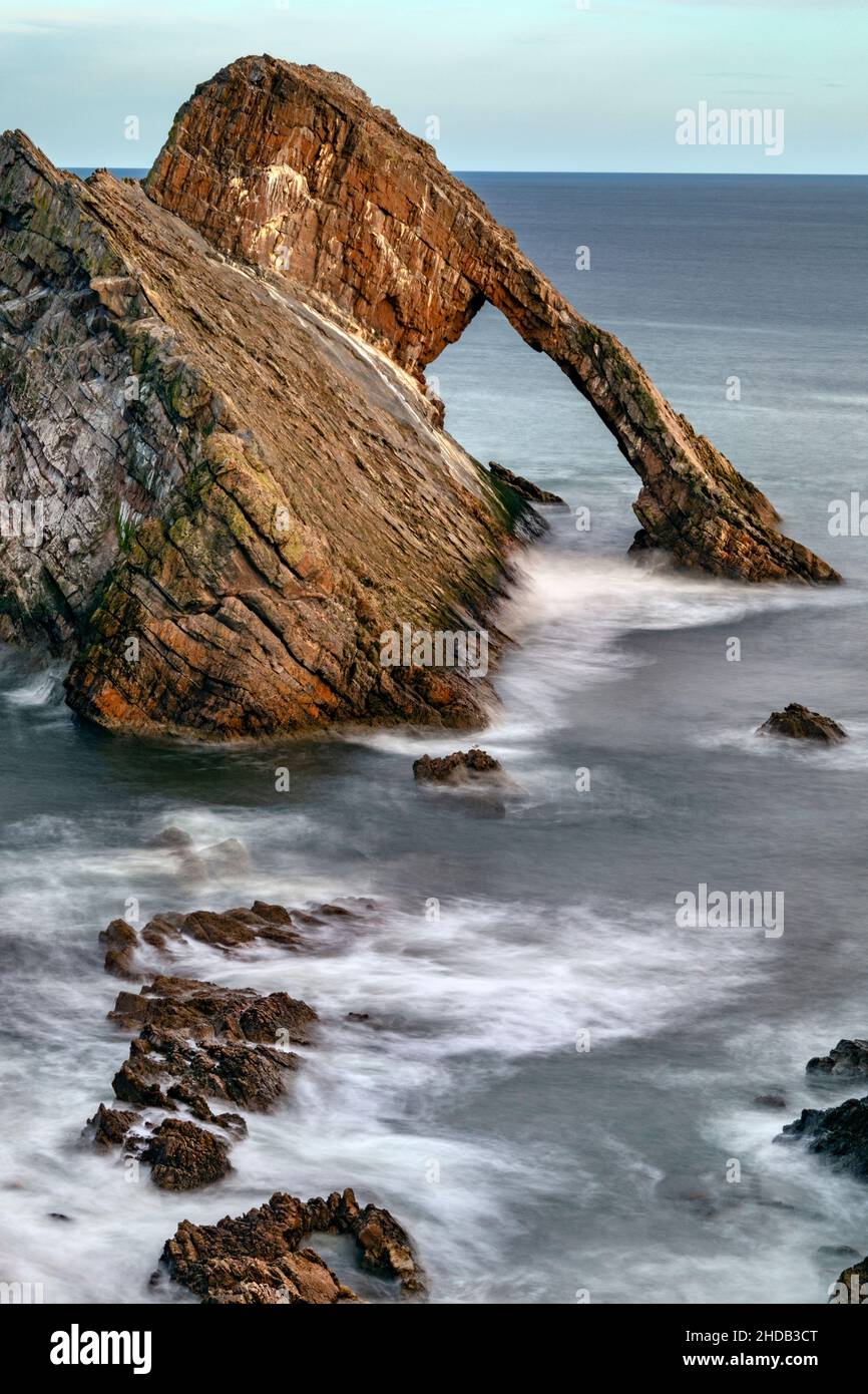 Bow Fiddle Rock - a natural sea arch near Portknockie on the northeast coast of Scotland. It is composed of Quartzite, a metamorphic rock which was or Stock Photo