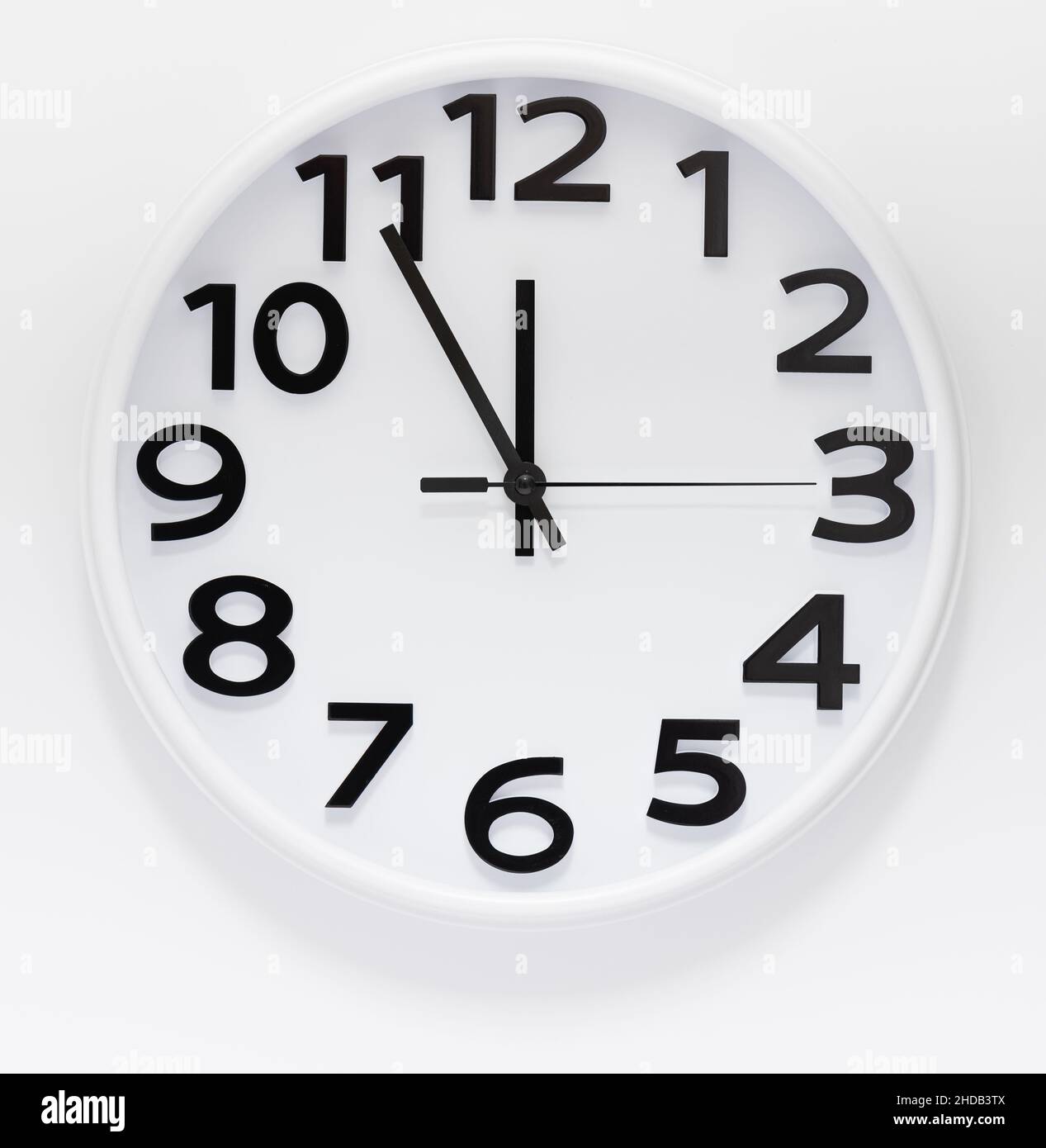 Big white round wall clock at 12, noon or midnight Stock Photo Alamy