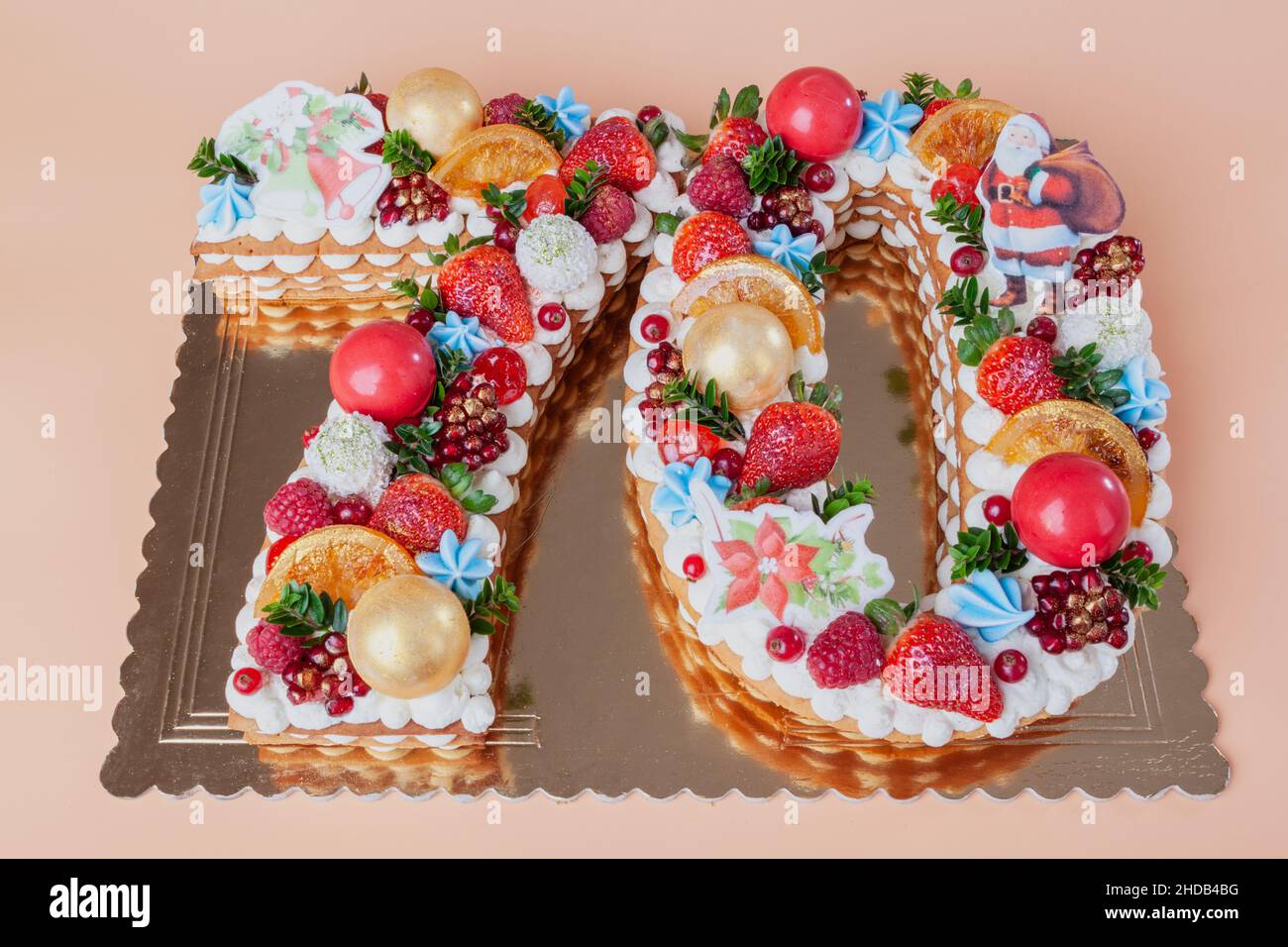 Anniversary cake Happy New Year in the shape of the numbers seventy from fruits and berries close-up from above. Stock Photo