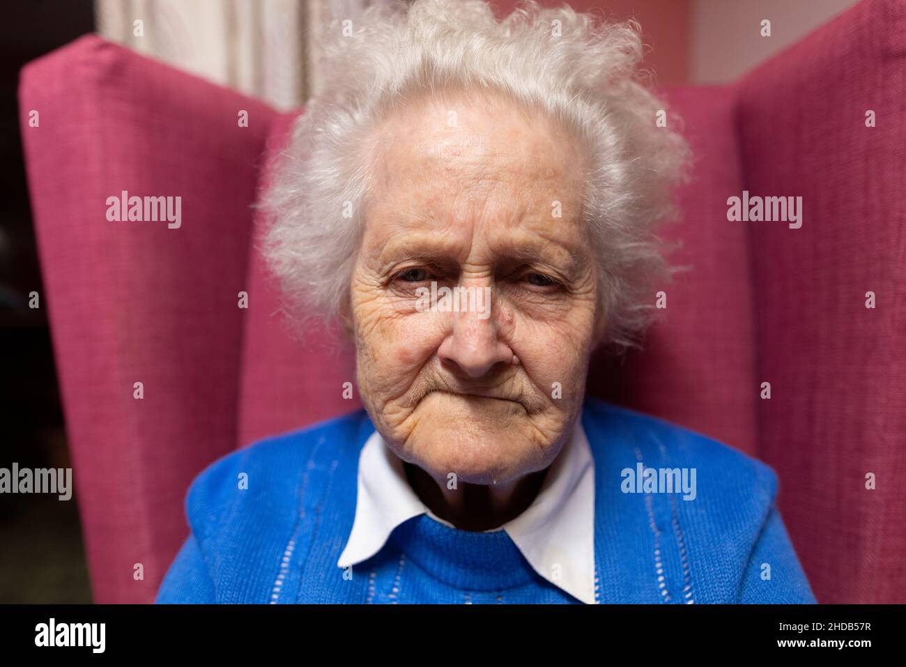 Elderly couple in their eighties sitting together at their residential ...