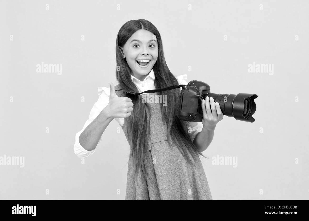 happy teen girl photographer use digital photo camera show thumb up, photographing Stock Photo