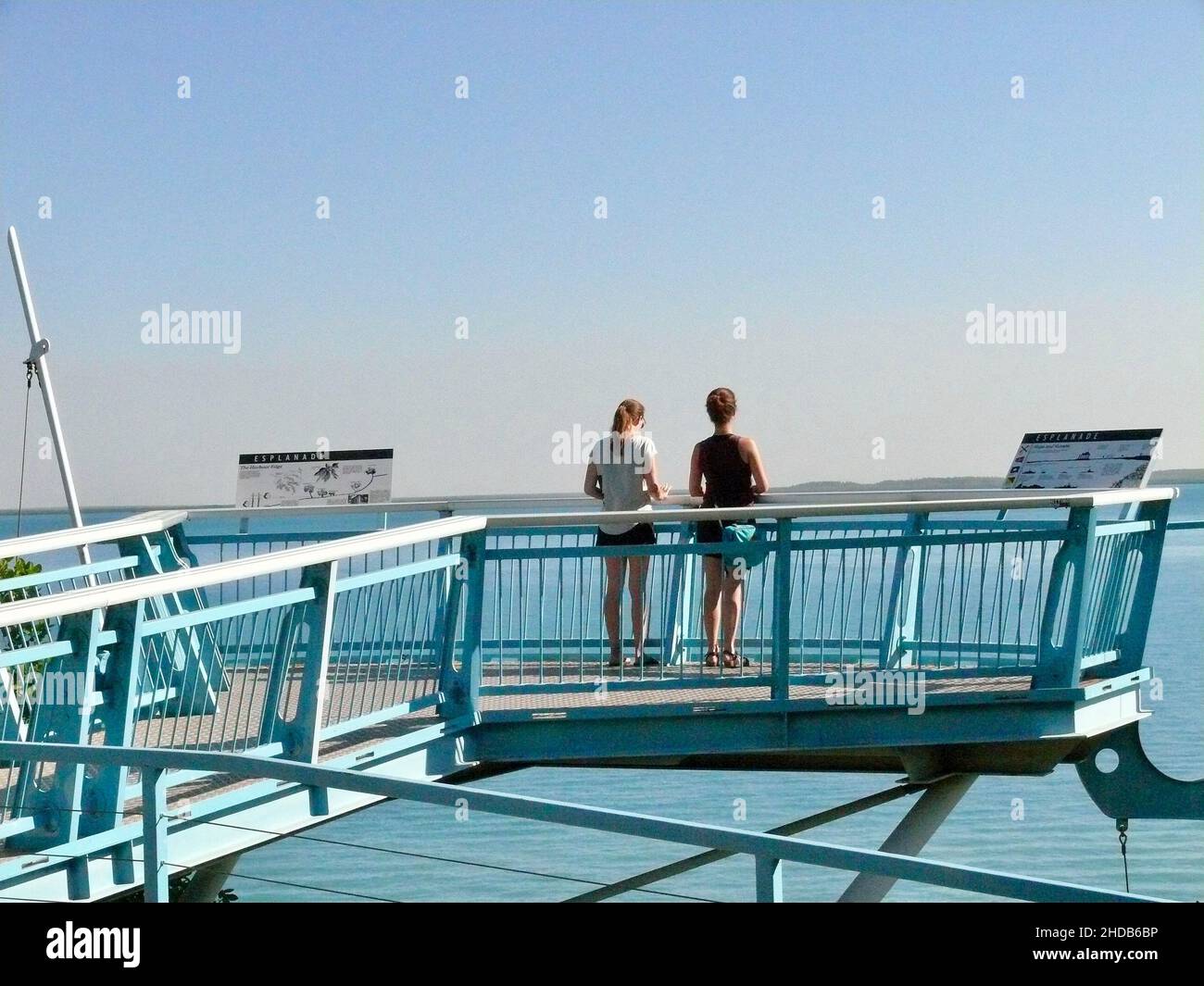 Tourists enjoying the view Drawin Harbor from a deck at The Esplanade Stock Photo