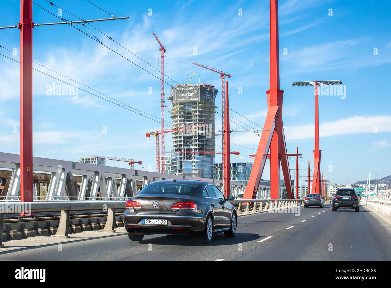 Budapest, Hungary - April 12, 2021: Traffic on Rakoczi Bridge in Budapest. Unfinished building and construction cranes on background Stock Photo