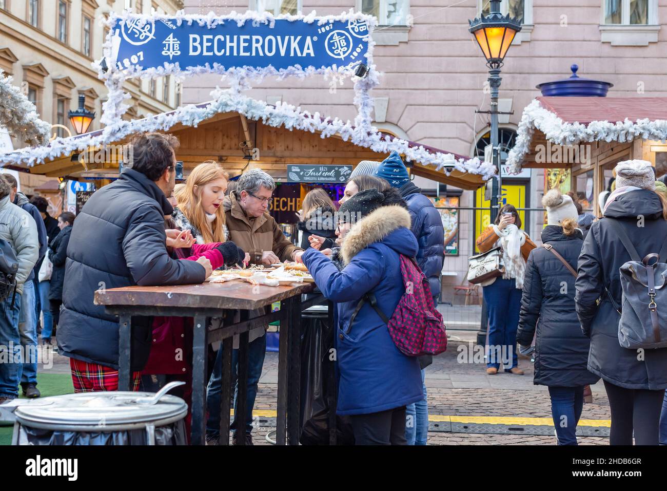 Budapest, Hungary - December 31, 2018: People eating fast food at Christmas market in Budapest, Hungary Stock Photo