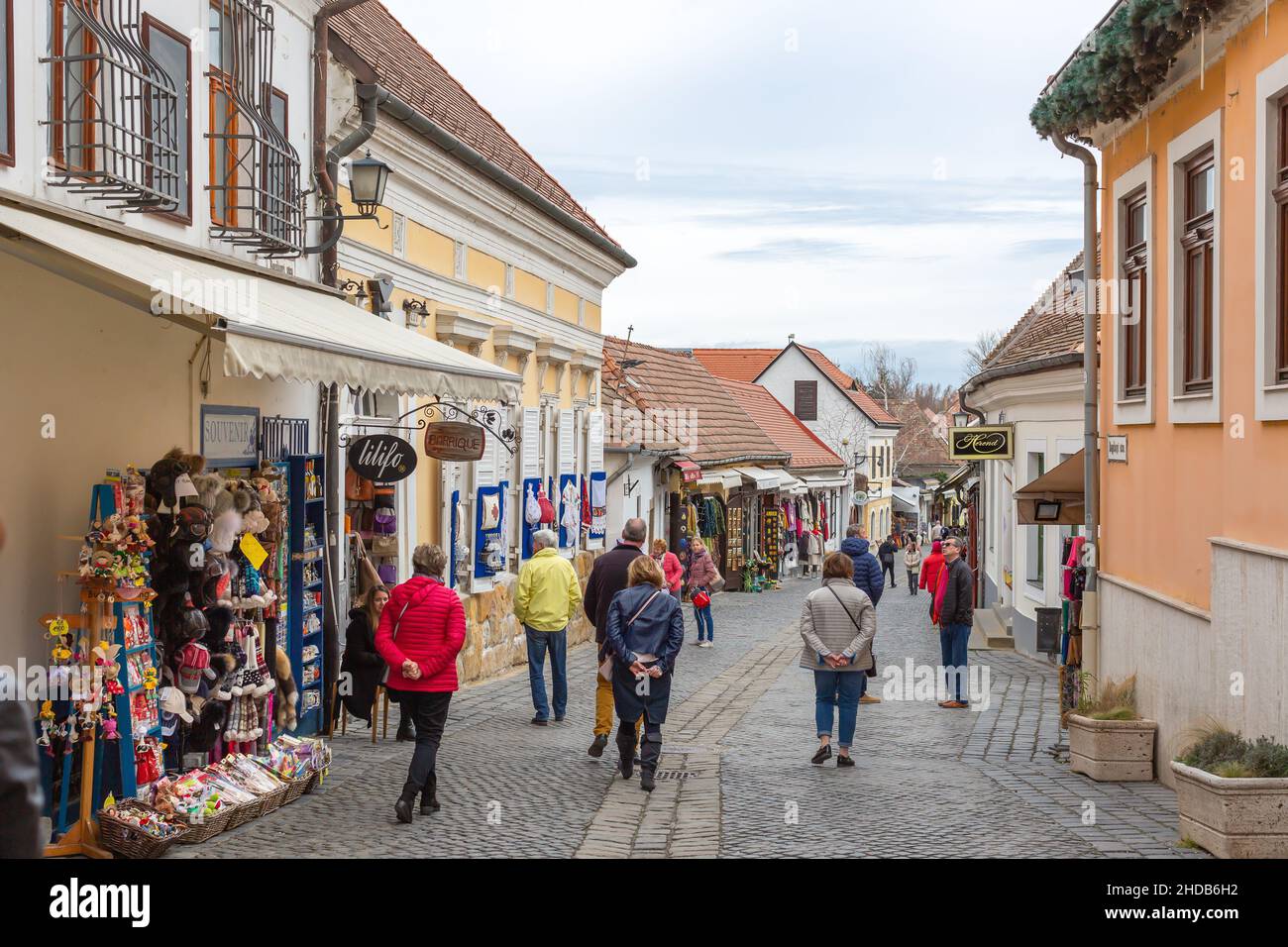 Szentendre, Hungary - March 10, 2019: Tourists walk along cozy street with souvenir shops Stock Photo