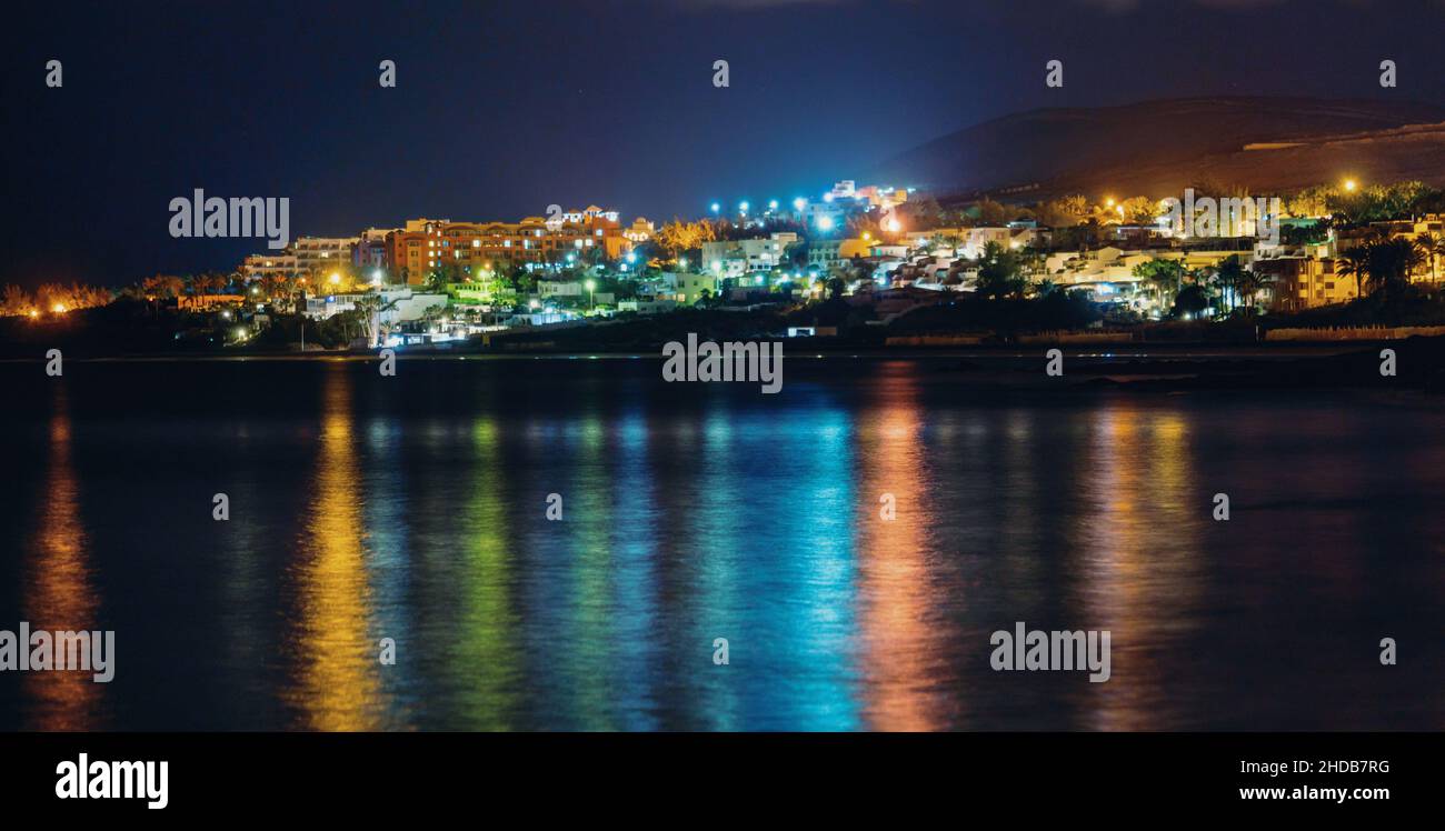 Reflection of the night city in the sea surface Stock Photo - Alamy