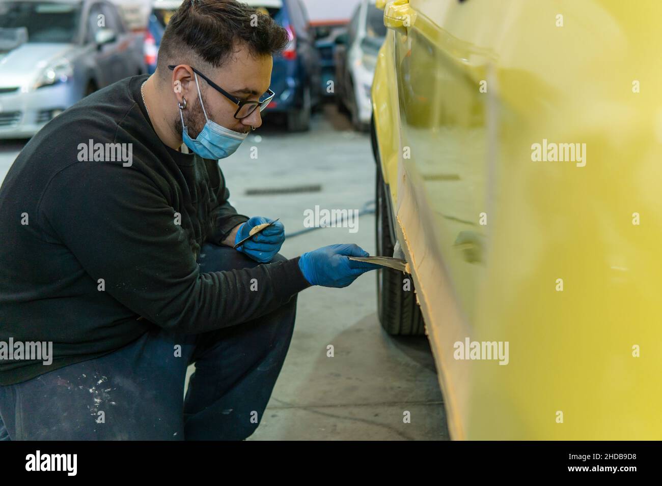 Auto Body Repair Seires Working On Putty Filler Stock Photo