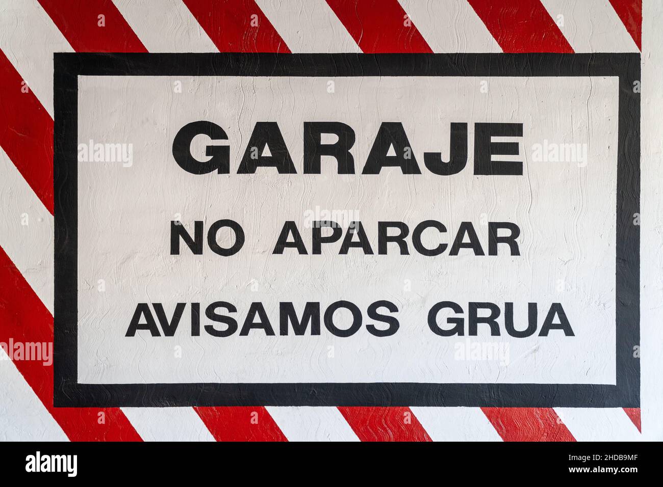Garage warning sign, no parking, tow truck warning, painted on the wall