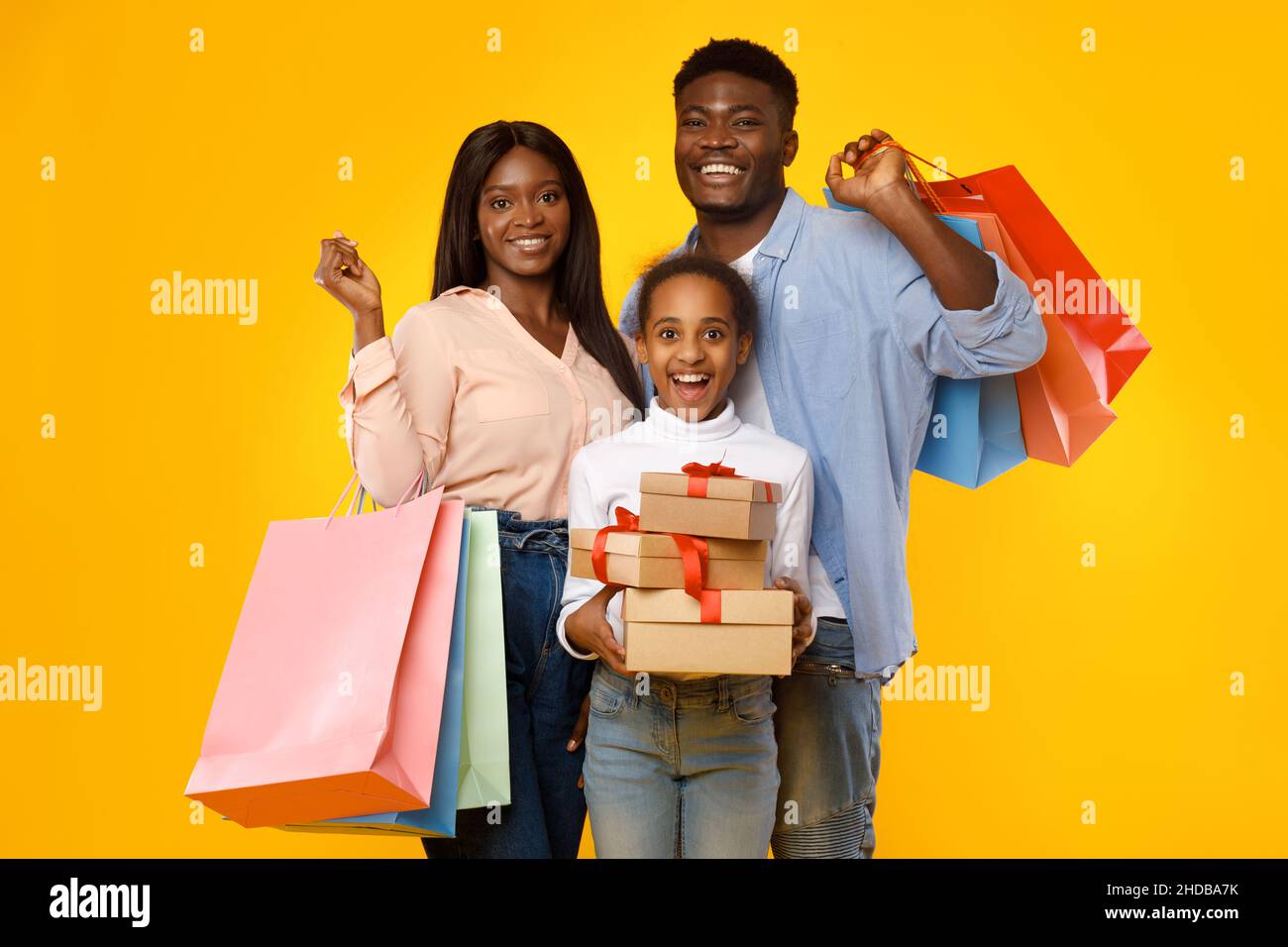 Happy black people holding shopping bags and gift boxes Stock Photo - Alamy