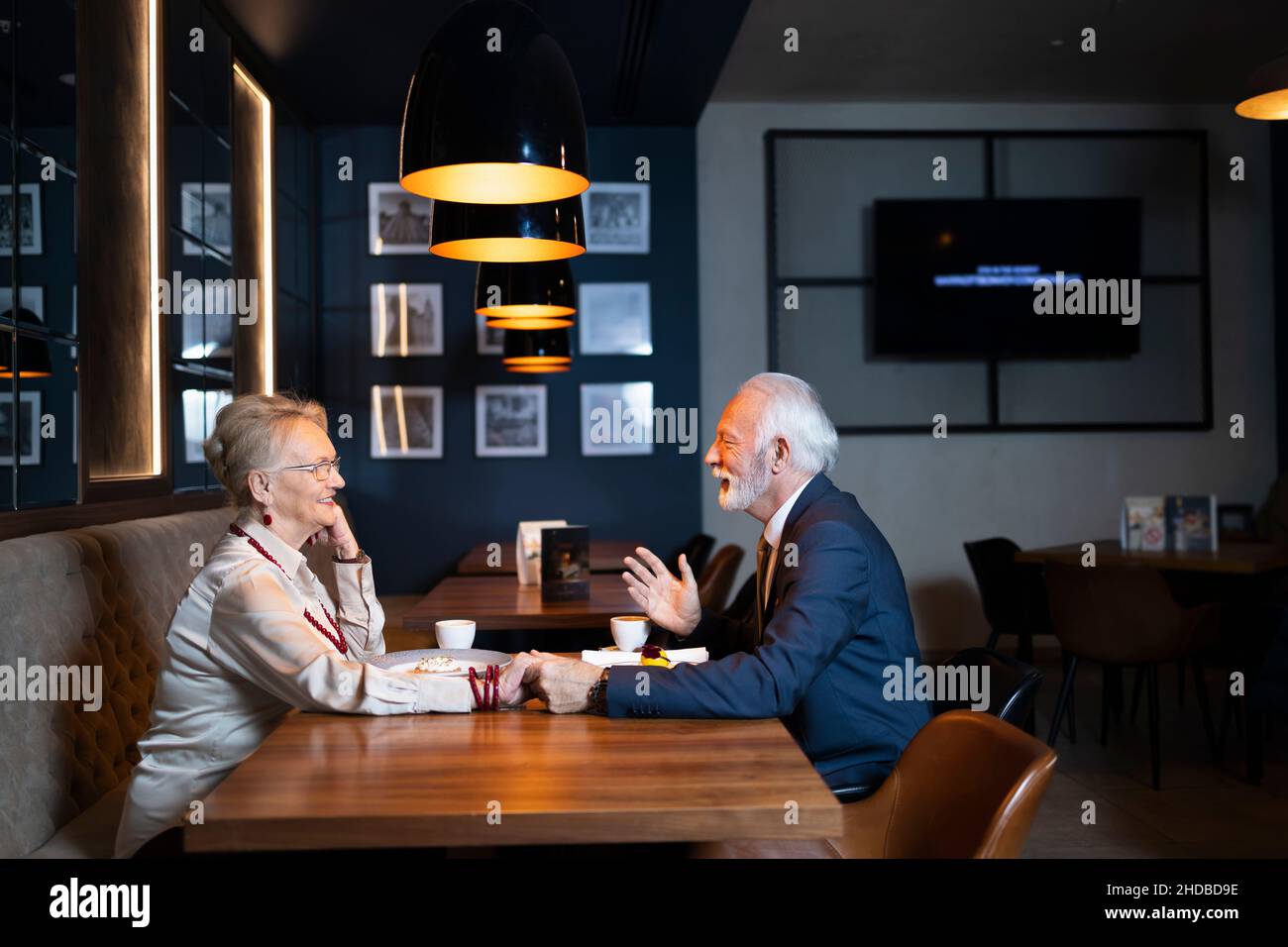 Elderly wife and husband having a conversation in an exclusive restaurant Stock Photo