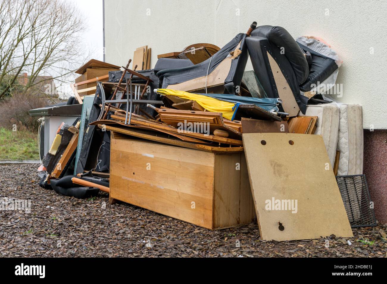 Bulky garbage heap in front of a house wall Stock Photo